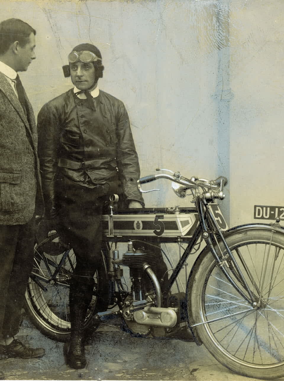 Jack Marshall, TT winner for Triumph in 1908, poses on his race mount. Gordon Gibson stands alongside.