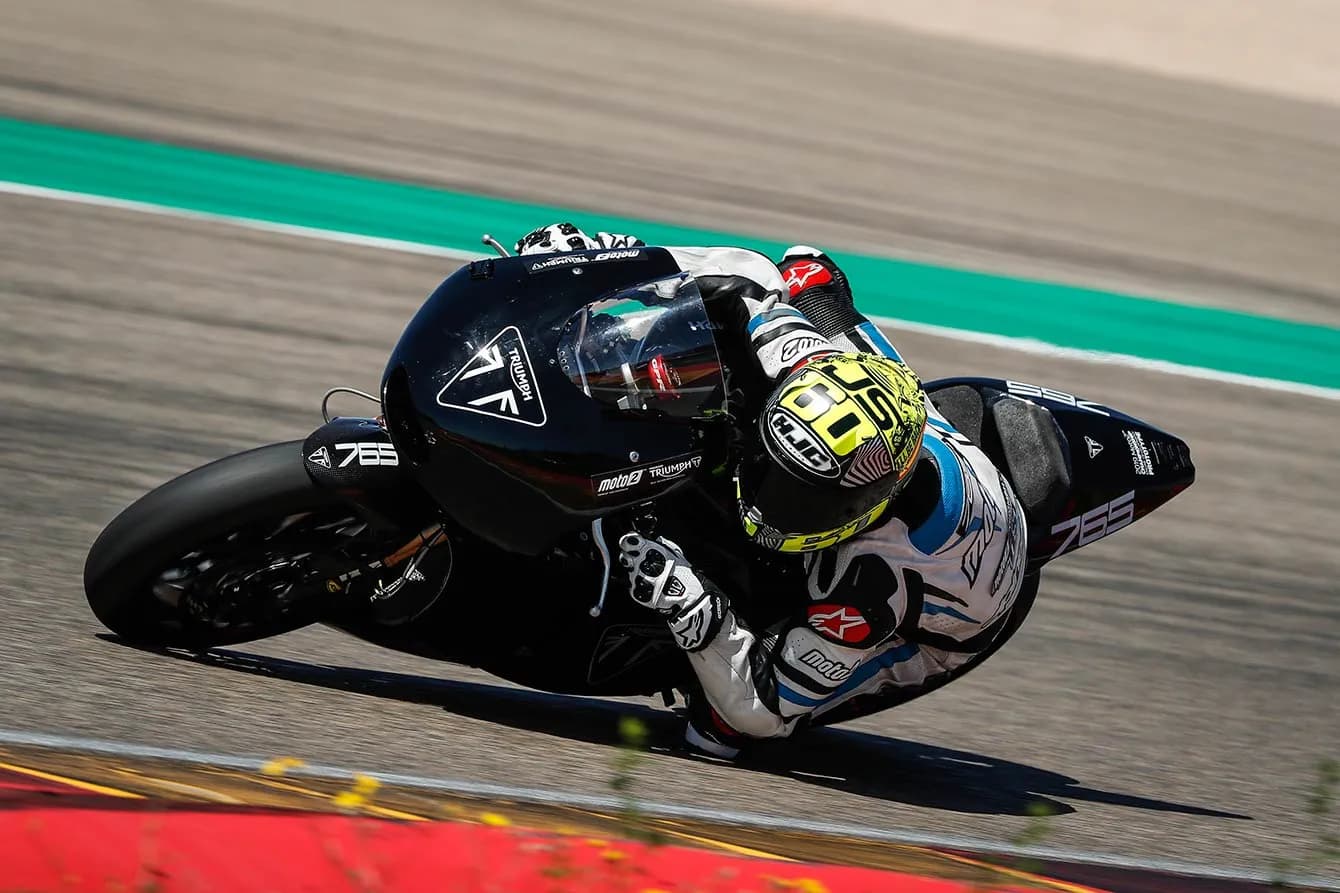 Racer on Triumph motorcycle corning on a track