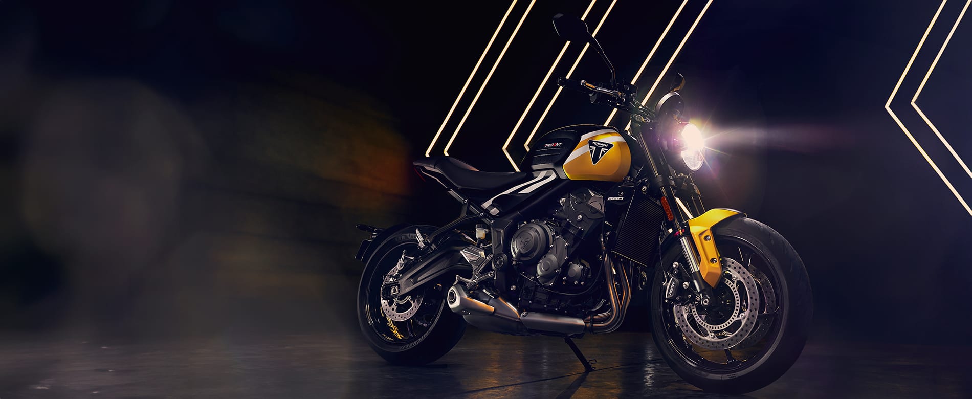 Triumph Trident 660 in cosmic yellow and sapphire black in studio setting