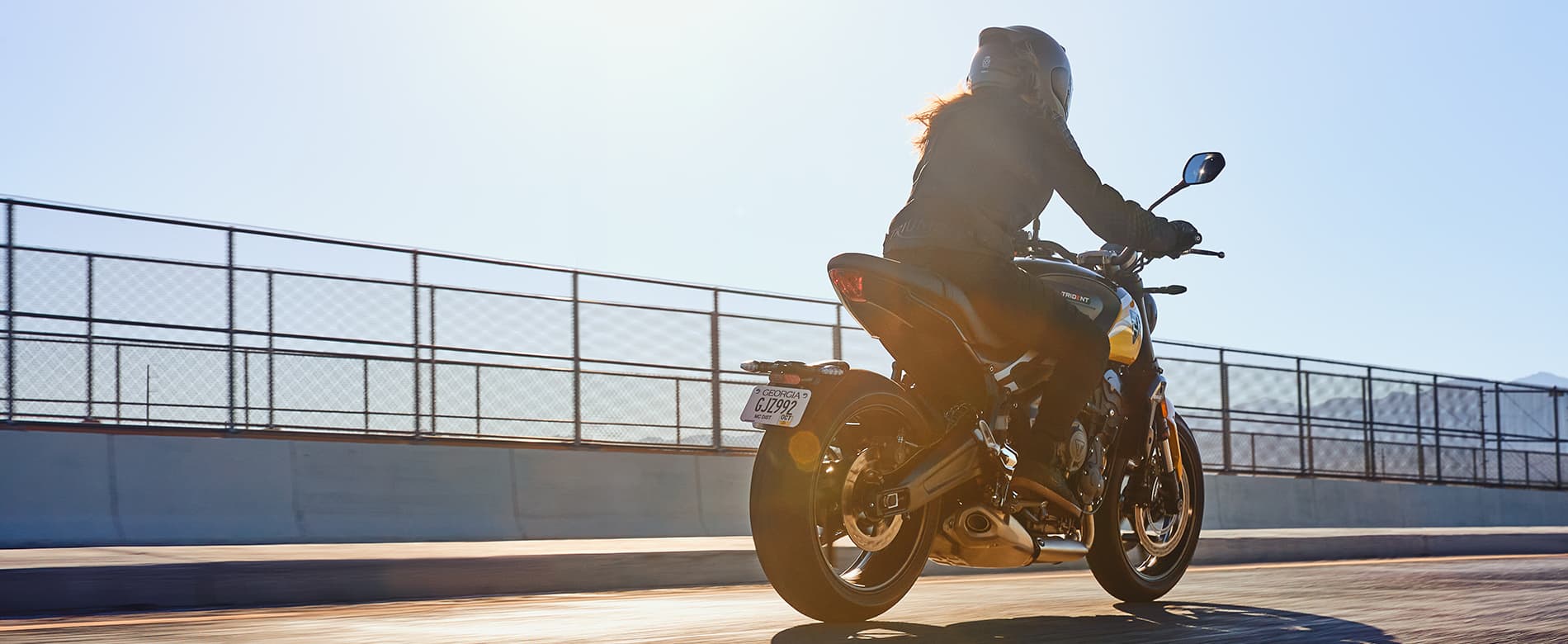 Triumph Trident 660 riding away from the camera