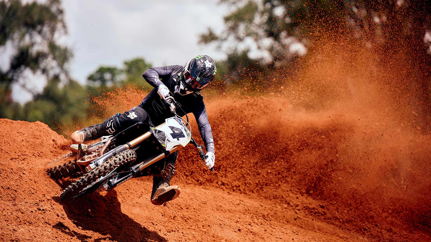 Triumph TF 450-RC kicking up some dirt on a berm