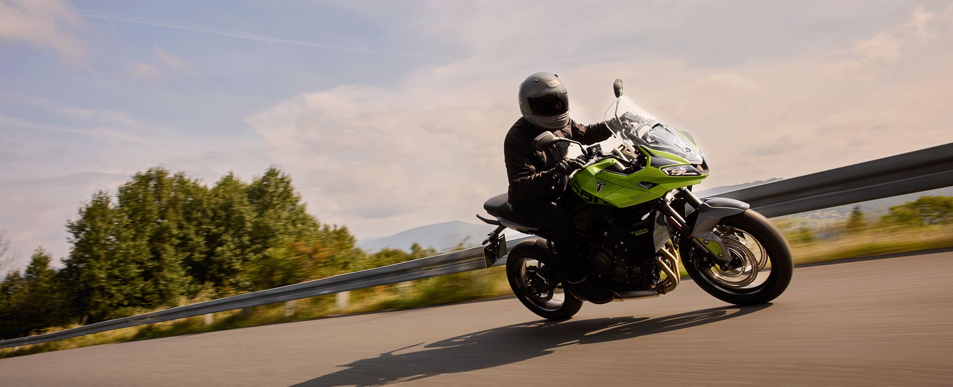 Tiger Sport 660 in Roulette Green riding on a mountain road