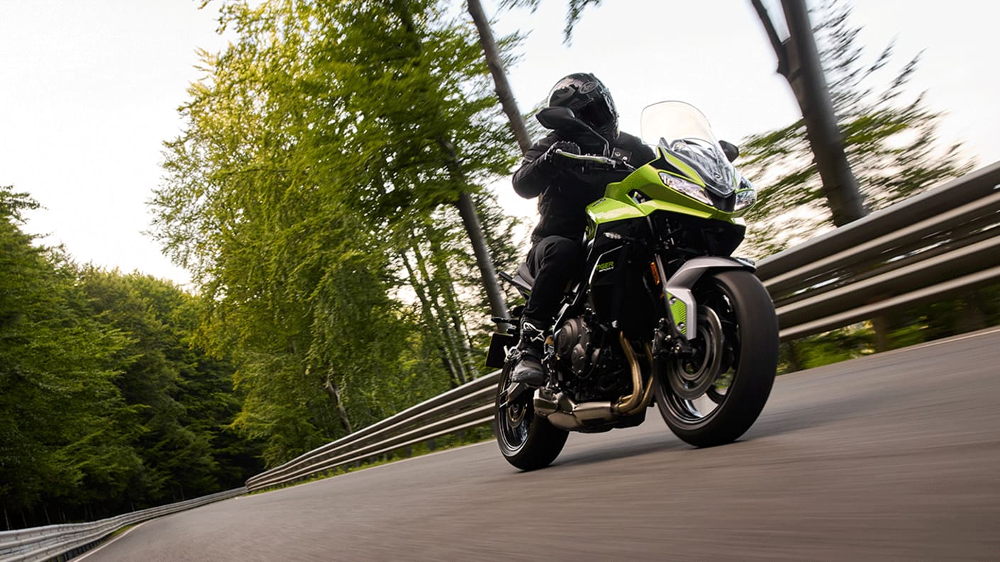 Tiger Sport 660 in Roulette Green fast down tree lined road