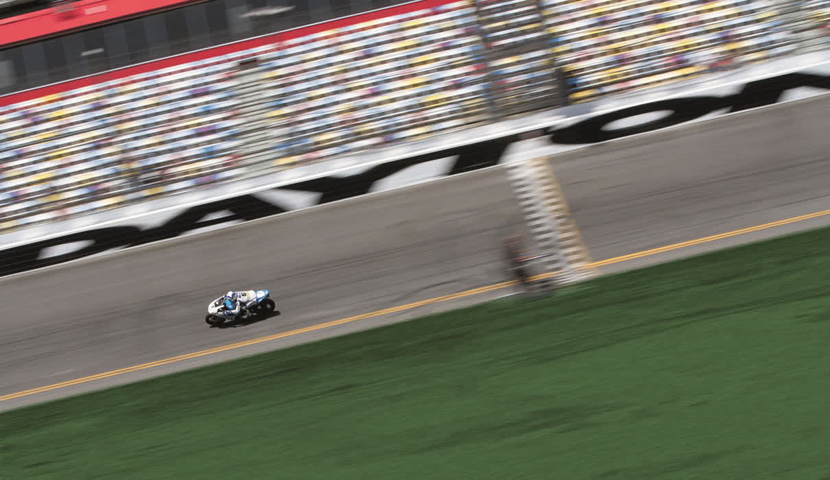 Distance shot of a rider on a motorcycle at a racing stadium