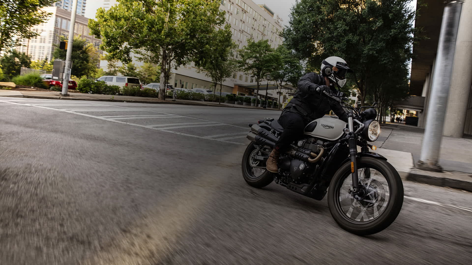 Person riding a Street Scrambler through a city.